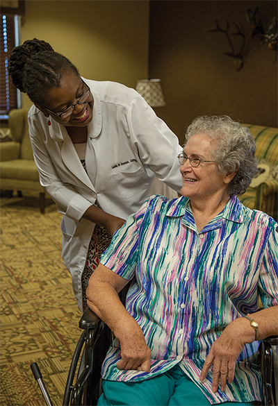 GA MedGroup nurse smiling at patient in wheelchair